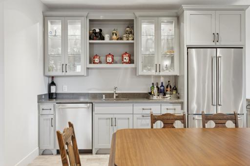 Lower level wet bar with full size refrigerator and dishwasher.