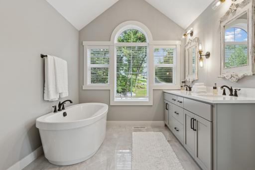 Spa like primary bathroom with soaking tub, large walk-in shower, double vanity and stunning finishes.