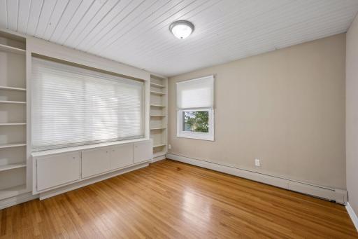 Three main floor bedrooms feature gleaming original wood floors.