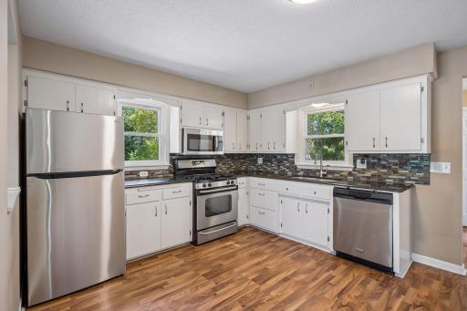 Laminate flooring throughout the kitchen living room and formal dining area.
