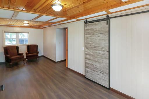 Main floor primary bedroom with a barn door covering the closet.jpg