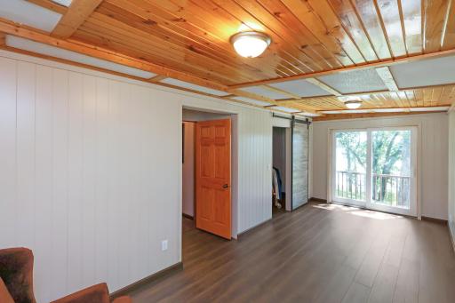 Main floor primary bedroom with a patio door to the deck.jpg