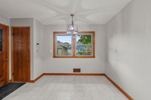 The dining room is bathed in natural light from surrounding windows.
