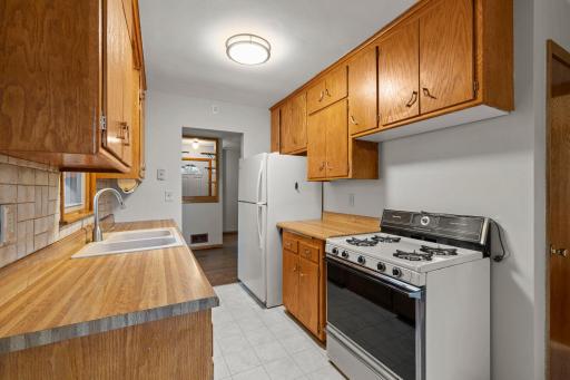 The kitchen also featuring new tile flooring throughout with gas appliances.