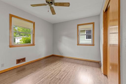 One of three bedrooms on the main level with side and front yard views.