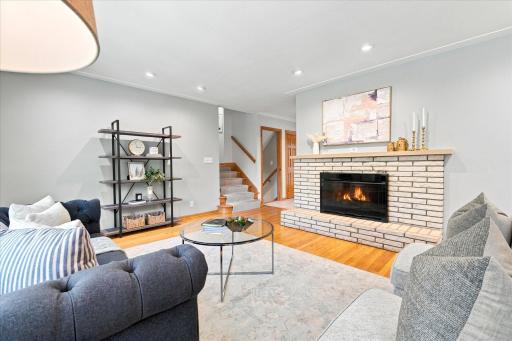 The living room vintage brick fireplace is cozy in chilly weather - and the gas insert makes it easy to warm up!