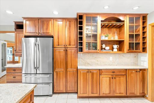 There is no shortage of cabinet storage in this kitchen - notice the full height pantry and built in hutch/serving bar?