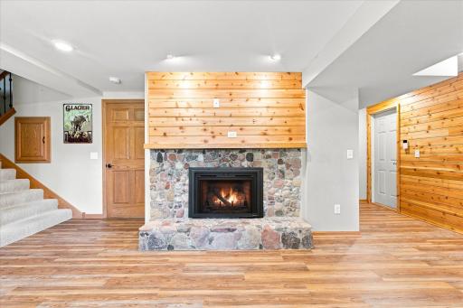 The original natural stone fireplace has a new gas insert for easy. warm fires on movie nights!
