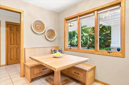 Custom built-in White Oak banquette setting with drawer storage underneath and a matching Oak table.