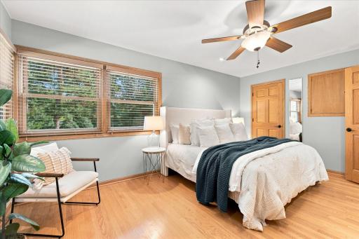 The primary bedroom upstairs offers a corner view of the gardens