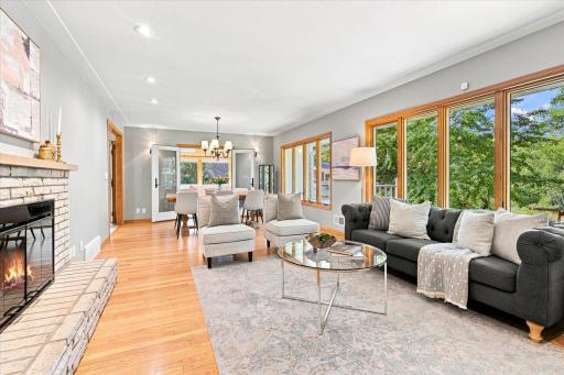 Long view of the living & dining spaces showing the HUGE picture windows overlooking the park like back yard.