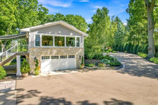 View of attached garage with vaulted family room above.