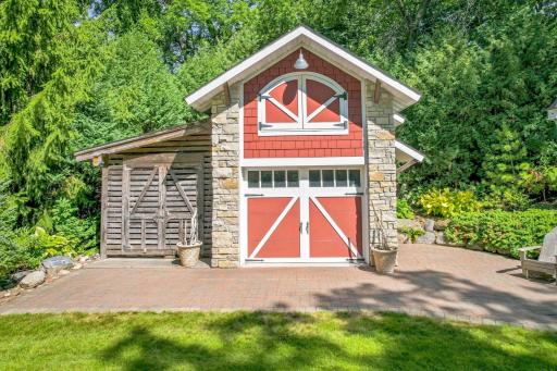 Custom designed with James Hardie siding and Natural stone, with attached "corn crib" style lean to for more garden storage.