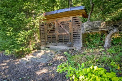 The little woodshed is situated near the "Campfire Patio" between the hidden path and the pond.