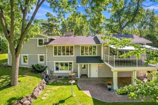 Arial view of back of home showing walkout to the large, covered paver patio