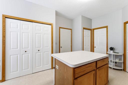 Double doors are for the pantry. Middle door is garage, right middle is entry closet and far right is the powder room.