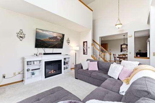 Large living room with flow from foyer, loft and dining room.
