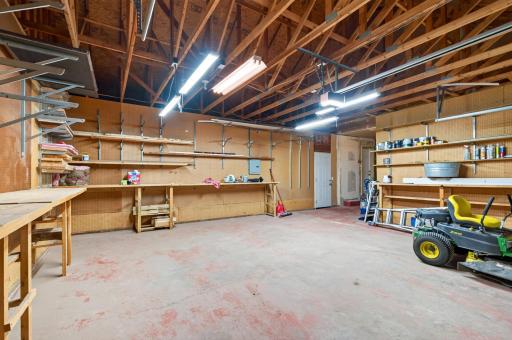 Lots of storage and work benches in 3 car garage and access to covered patio