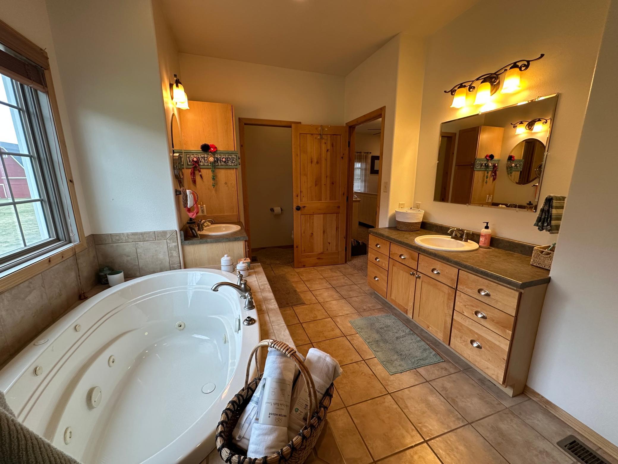 Primary bathroom with heated ceramic tile floors.jpeg