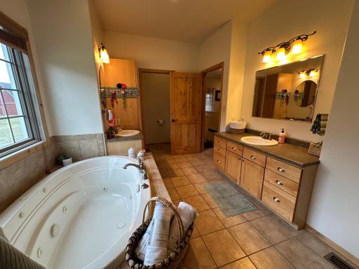 Primary bathroom with heated ceramic tile floors.jpeg