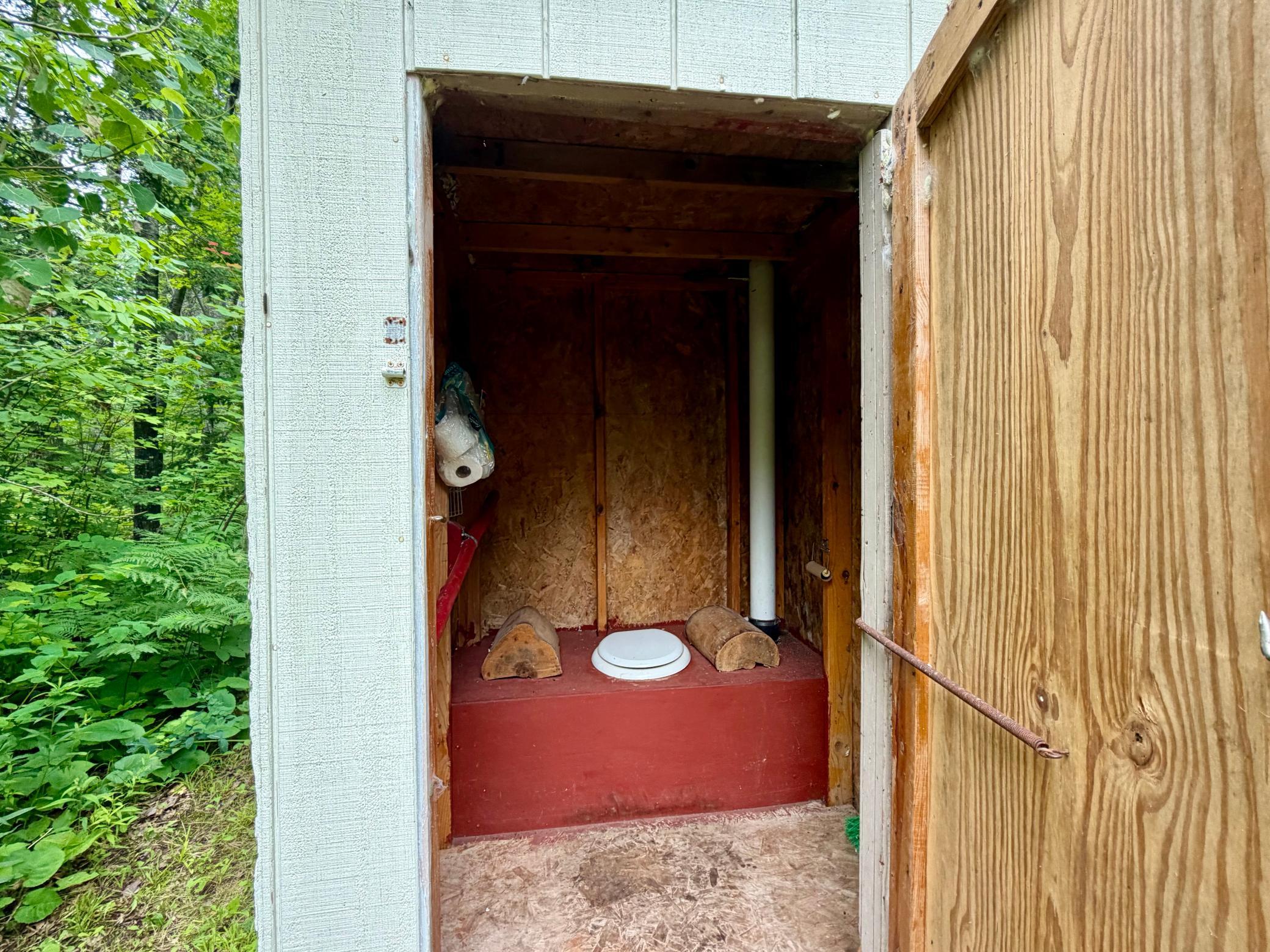 outhouse with 55 gal barrel