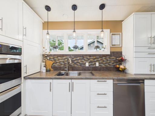 Nice kitchen window and tasteful backsplash