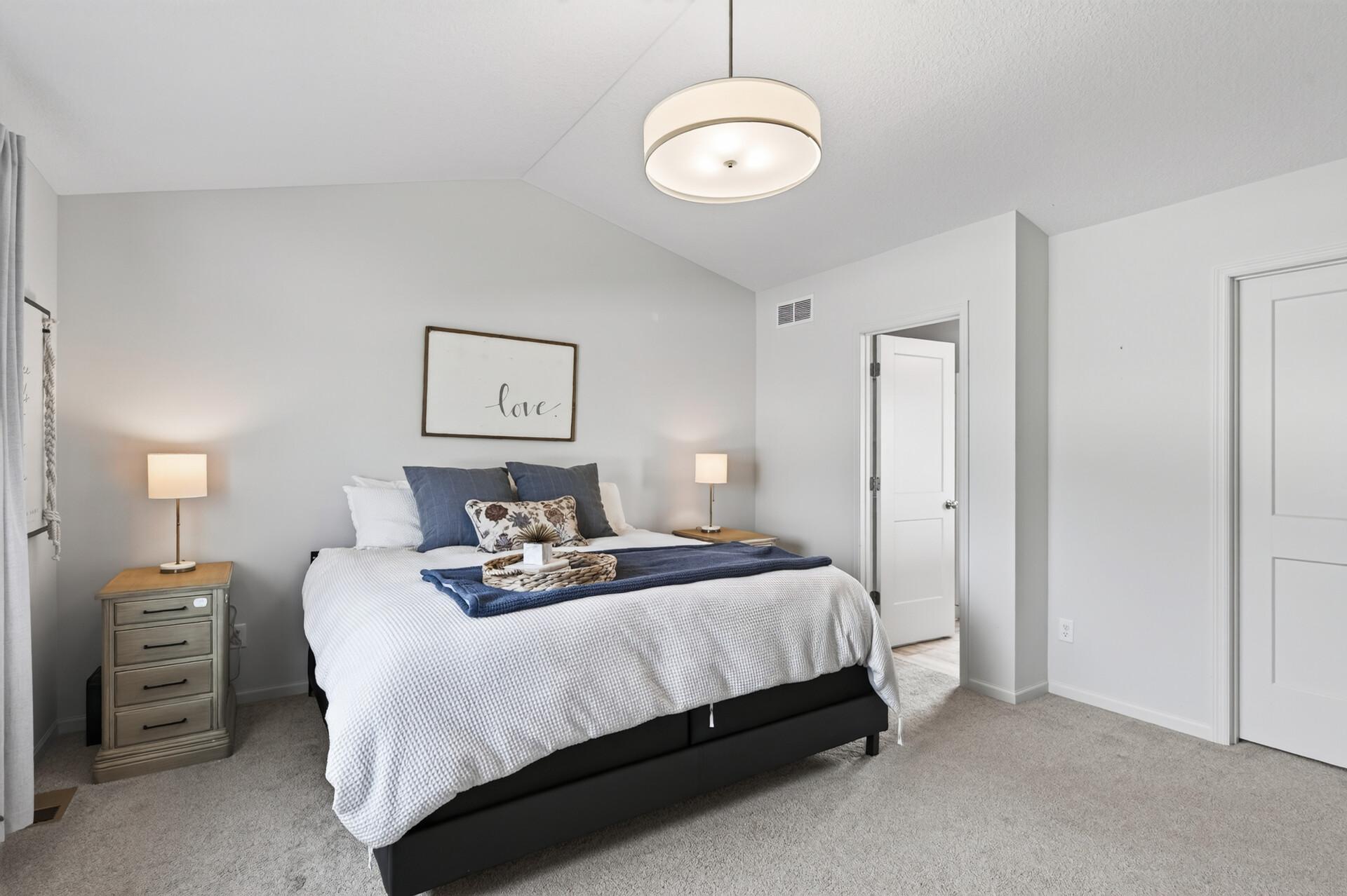 Primary bedroom with a generous walk-in closet and private full bathroom.