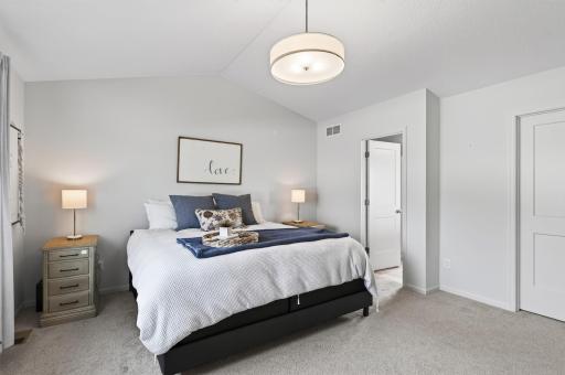 Primary bedroom with a generous walk-in closet and private full bathroom.