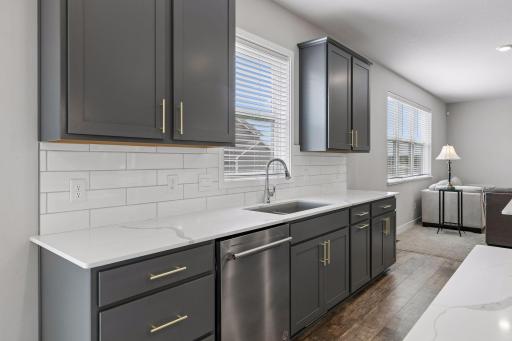 Quartz countertops and tile backsplash