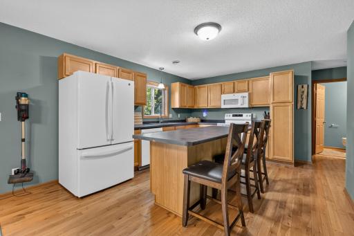 Kitchen features cabinet storage and an "Eat-in" island