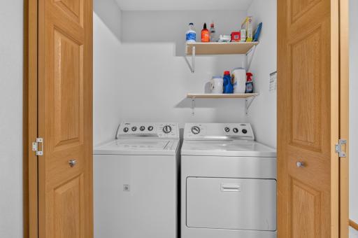 Laundry Closet with washer / dryer and floating shelves