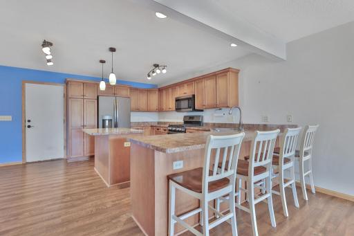 Spacious Kitchen features an Island - Pantry Area - Stainless Steel Appliances - LVP Flooring - Breakfast Bar for Seating or Serving