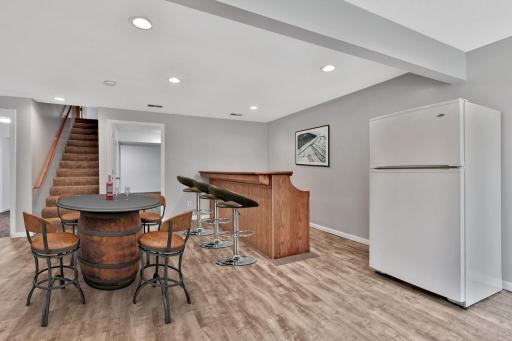 Lower Level Family Room Area with Bar and Extra Refrigerator - Virtually Staged
