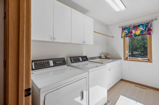 The separate laundry room has a Speed Queen commercial washer and dryer and is so bright and cheery