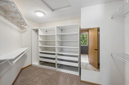 Large walk-in closet with custom built-ins