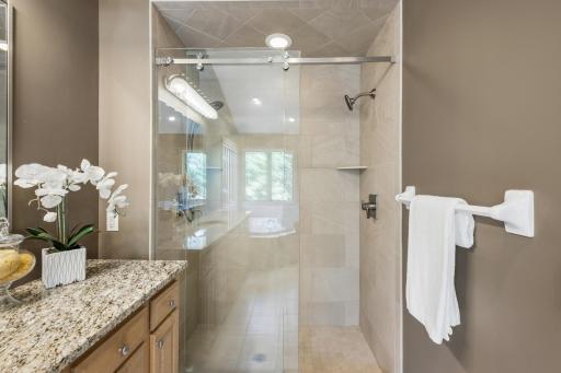 Separate tiled walk-in shower with glass door