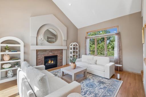 This light filled living room has gorgeous hardwood floors and a gas fireplace