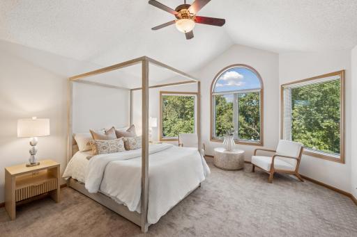 This primary suite will impress you with the treetop views and all the amenities