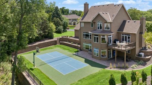 The highlight of the backyard is the new sport court. It is lined for pickleball and also features a basketball hoop.