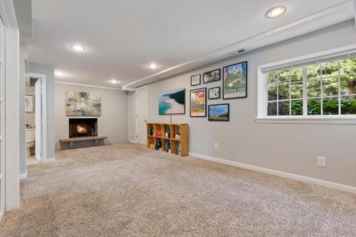Lower level family room with wood burning fireplace