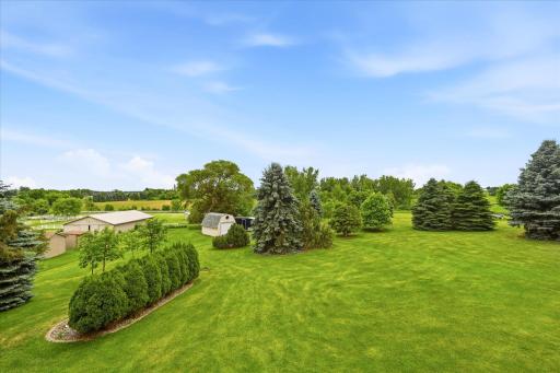 Expansive green space provides room for recreation, gardening, and outdoor enjoyment.