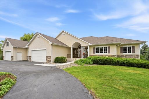 Walkout rambler situated on 2.5 scenic acres surrounded by mature trees, established gardens, and peaceful views.