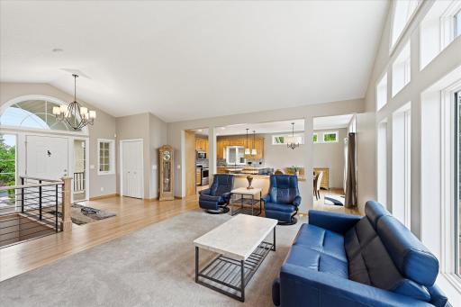 Vaulted ceilings and expansive windows fill the main living area with natural light and create an open, airy atmosphere.