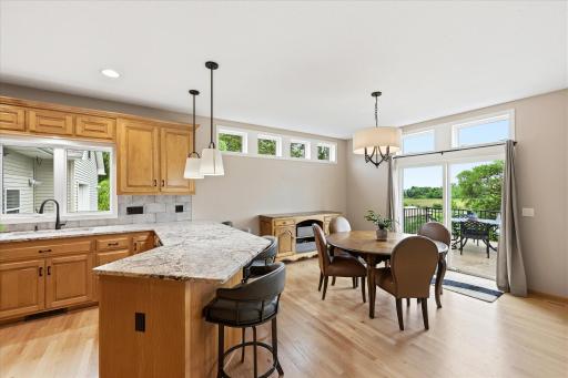 Sun-filled dining area with direct access to the deck creates an ideal indoor-outdoor living experience.