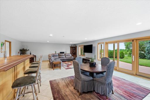 Bright lower-level living spaces feature large windows and direct access to the outdoors