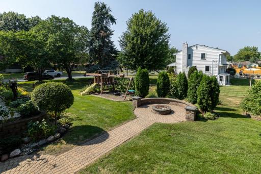 Beautiful Backyard with Kids Play Area and Custom Paver Fire Pit