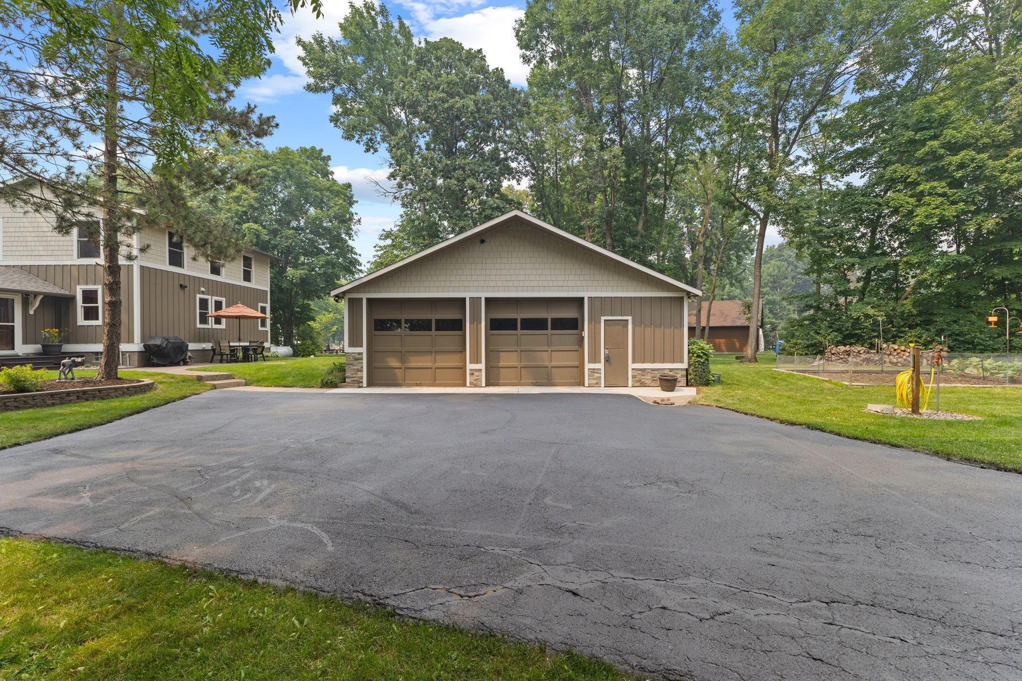 Oversized 4-car garage with abundant storage, durable cement board siding, covered gutters, and an asphalt driveway professionally resealed in Summer 2026.