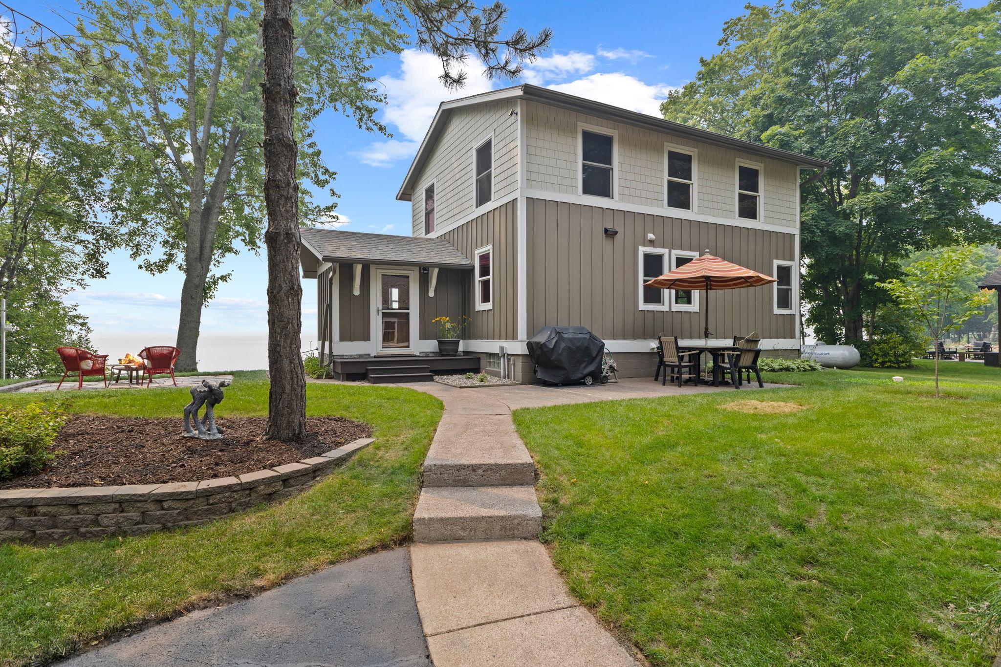 Designed for lasting beauty and low-maintenance living, this two-story home showcases cement board siding, covered gutters, and breathtaking panoramic views of the lake.