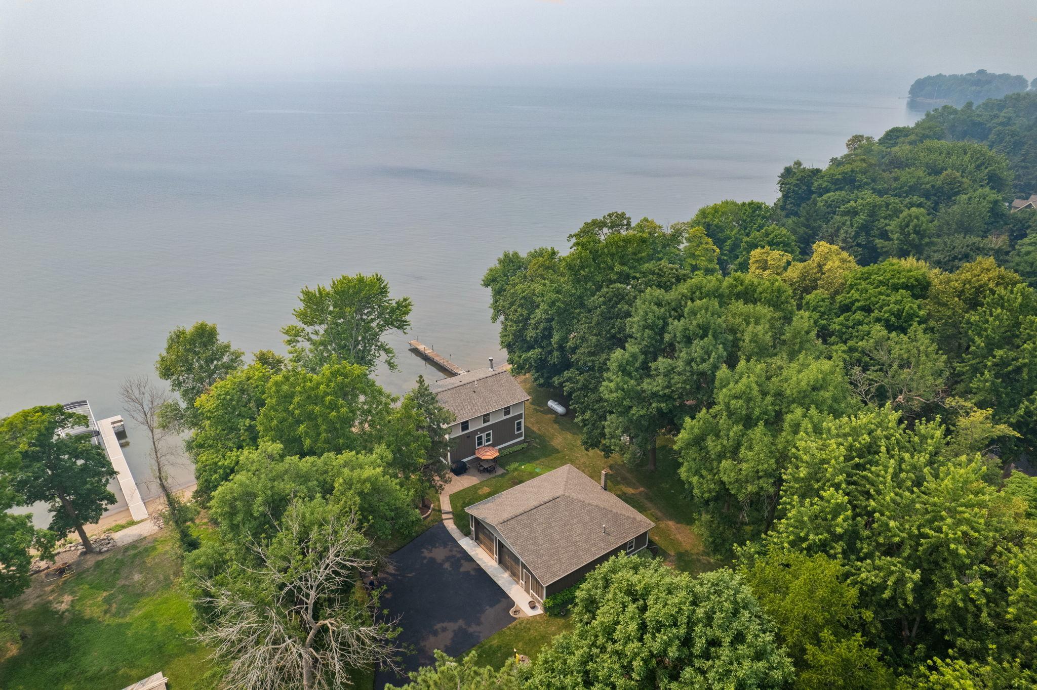 Nestled on a half acre lot on the water with many mature trees for your privacy.