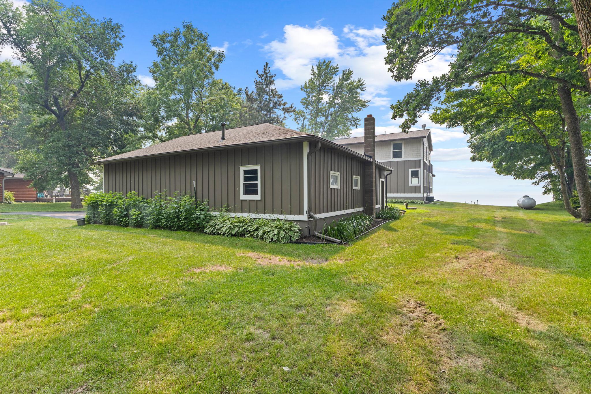The garage also matches the lake home, with newer Hardy cement board siding and covered gutters